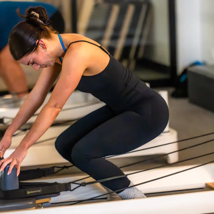A member pressing into the Reformer foot bar